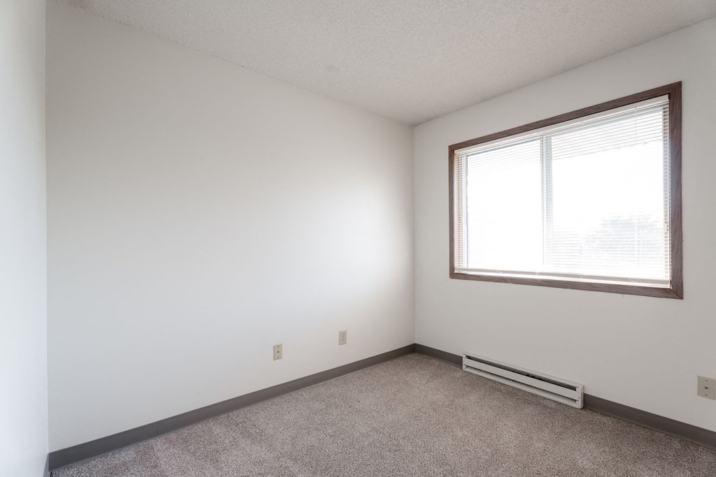 A room with a window and a radiator on the floor at Rosemont Place Apartments, Des Moines, 50320