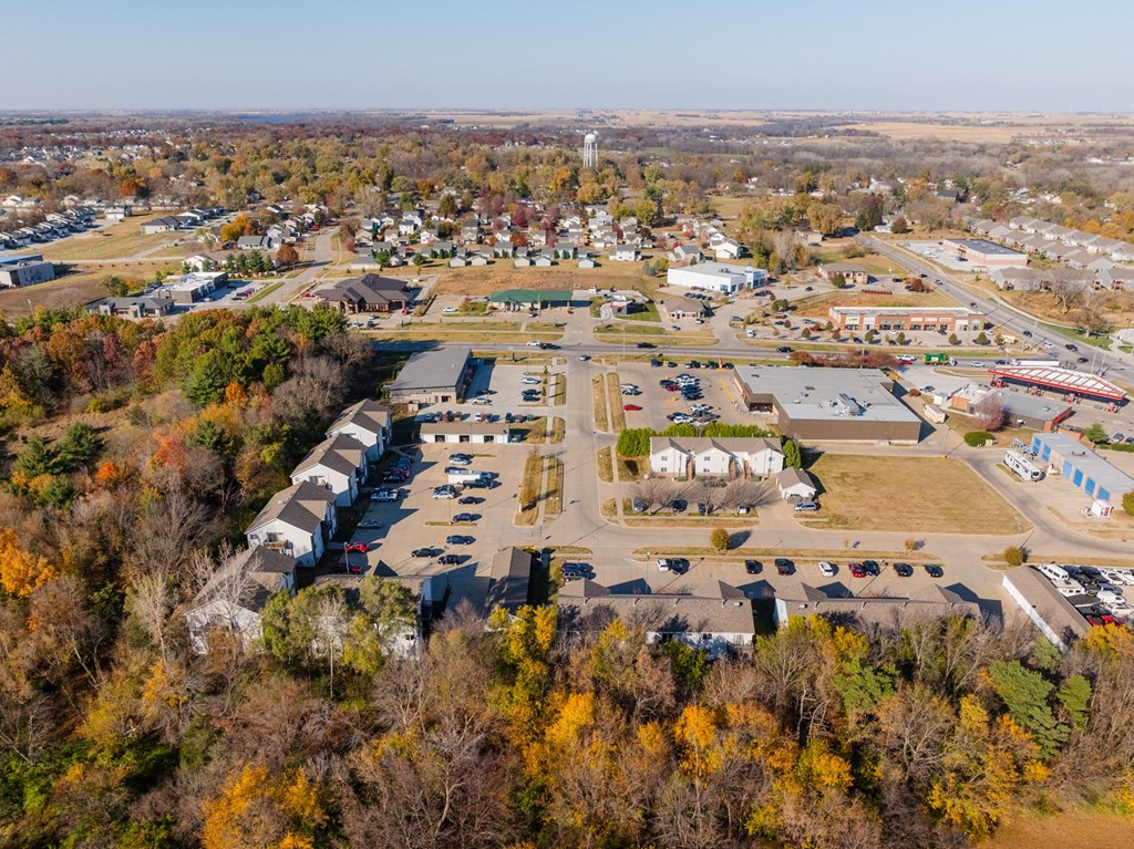 An aerial view of a small town with a large parking lot in the foreground. at Saylorville Lakeside, Polk City, IA