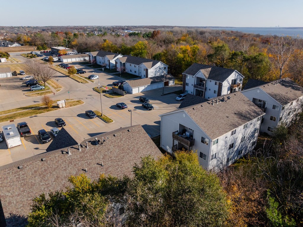 A parking lot with cars and a building in the background. at Saylorville Lakeside, Polk City, IA, 50226