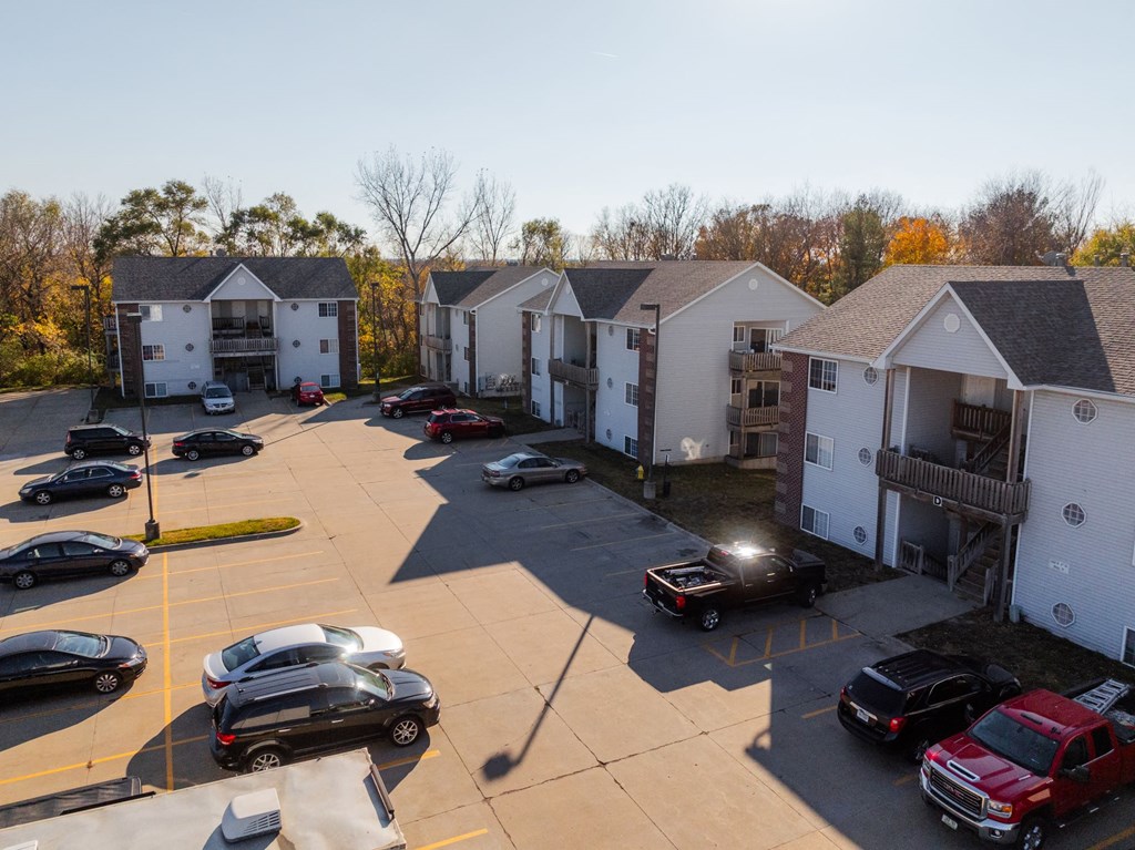 A parking lot with cars and apartment buildings in the background. at Saylorville Lakeside, Polk City, IA, 50226