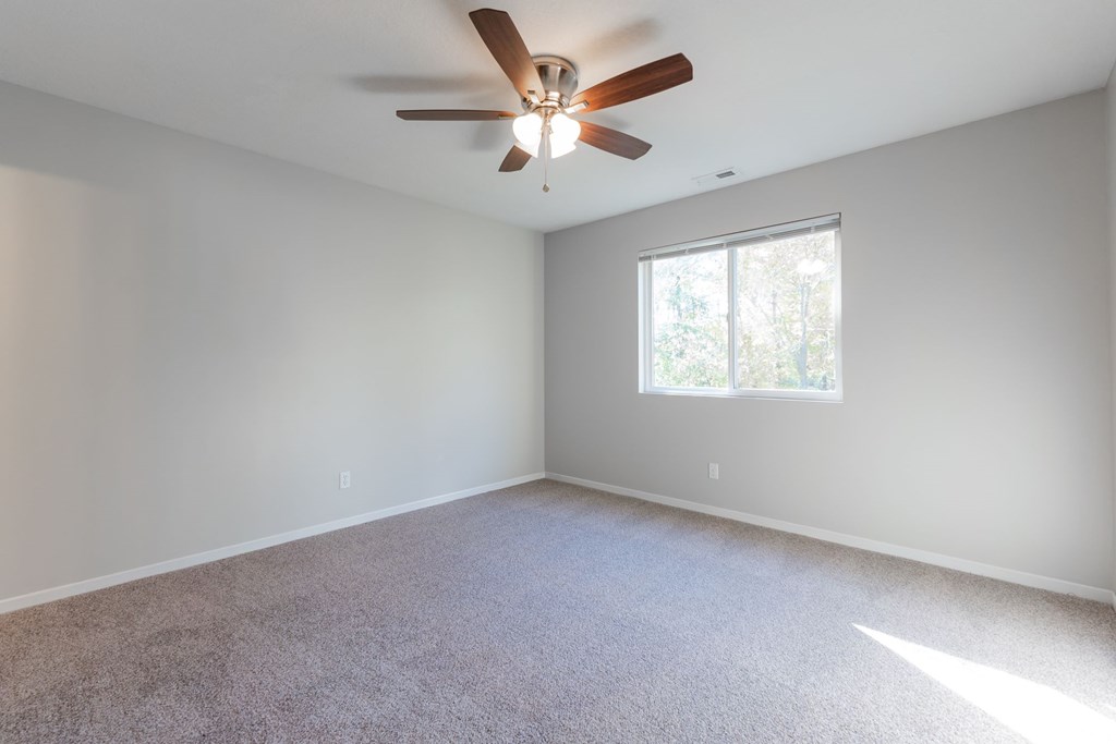 A room with a ceiling fan and a window. at Saylorville Lakeside, Polk City, IA, 50226