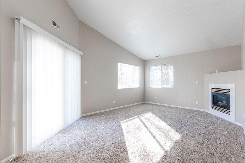 A sunny room with a carpet, a fireplace, and a window. at Saylorville Lakeside, Polk City, 50226