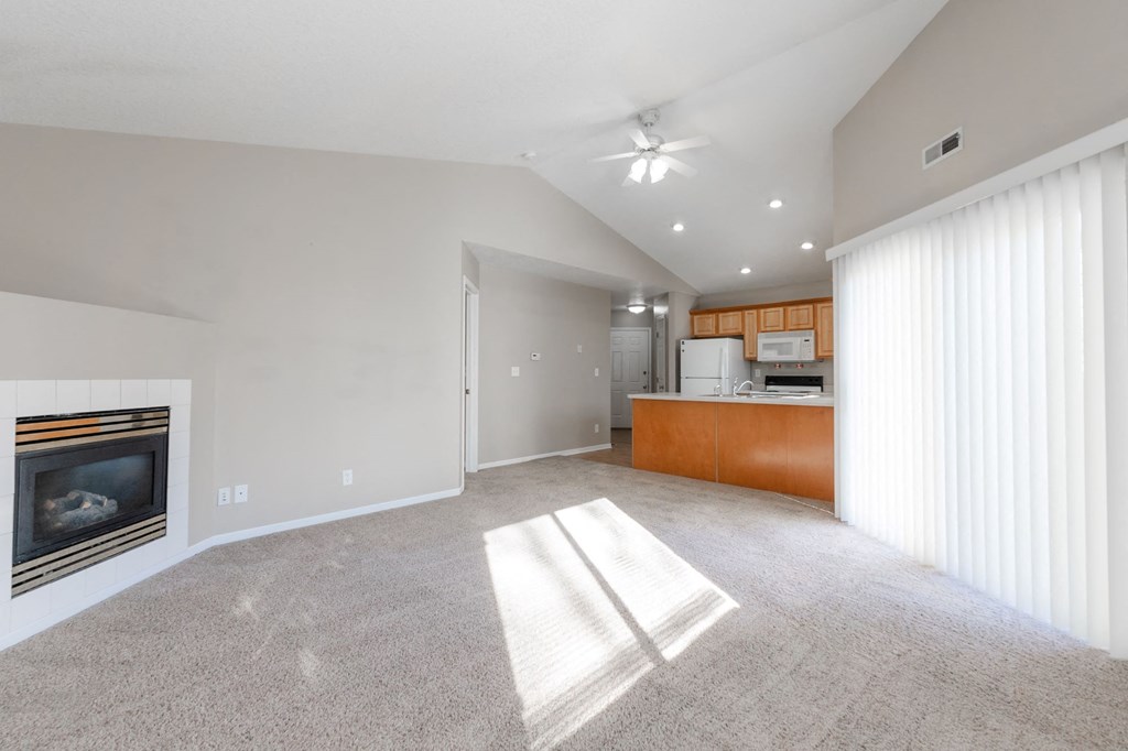 A spacious living room with a fireplace and a carpeted floor. at Saylorville Lakeside, Polk City, 50226