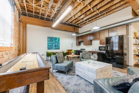 A room with a pool table and a couch.