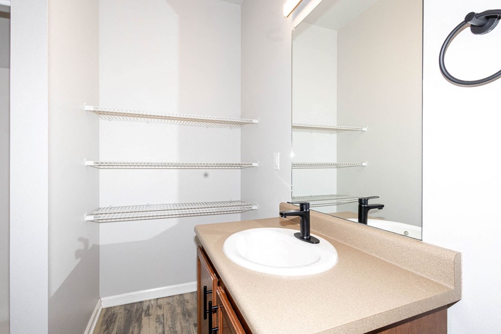 A bathroom with a sink and a mirror at Meadowlark Place Apartments, Georgia