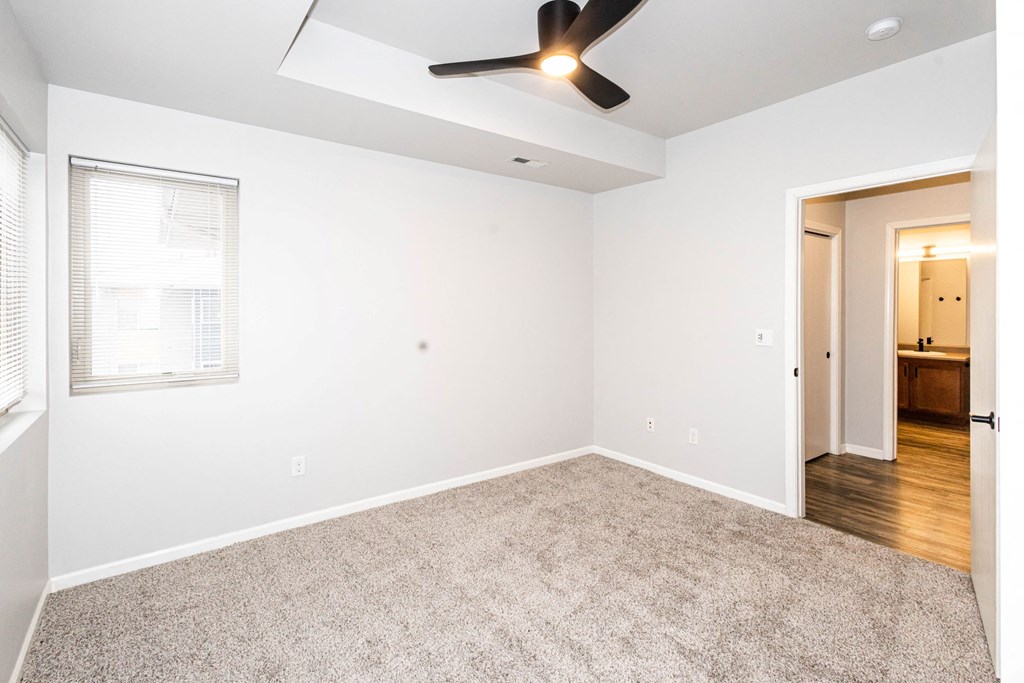 A room with a carpeted floor at Meadowlark Place Apartments, Grimes, IA,  50111