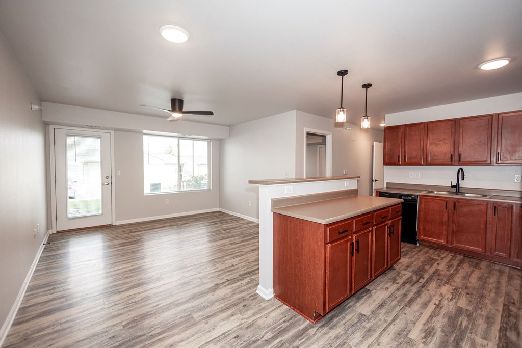 A kitchen with wooden cabinets and a countertop at Meadowlark Place Apartments, IA, 50111