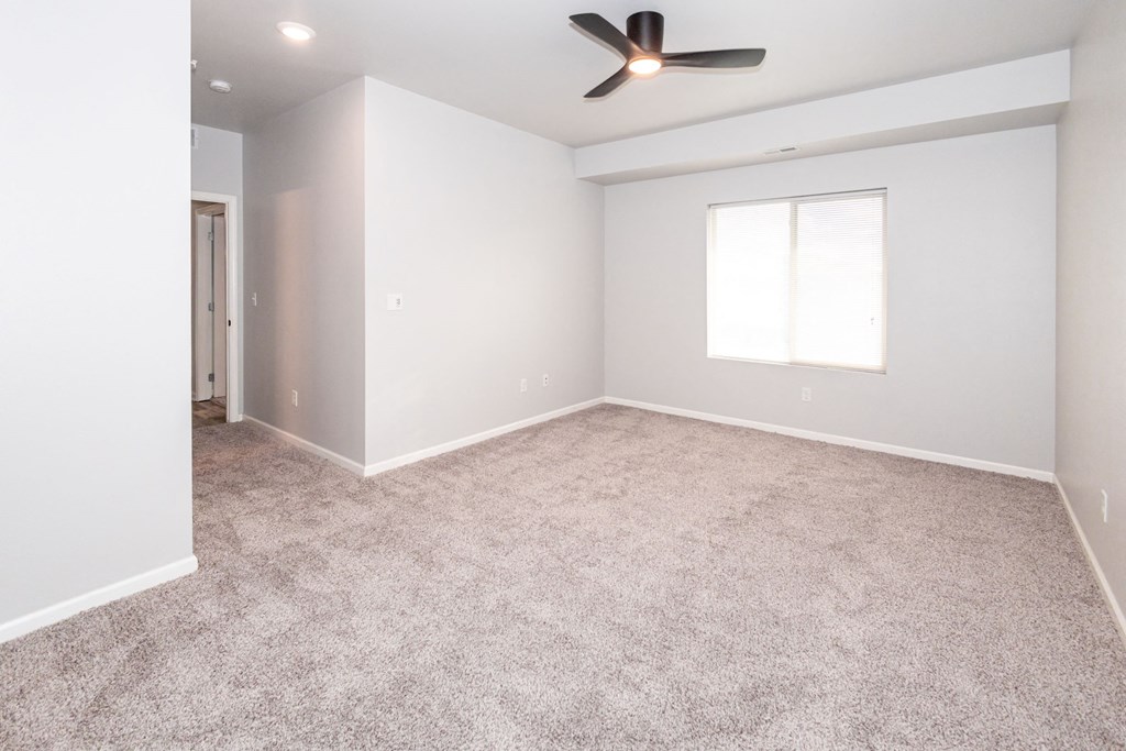 room with ceiling fan and window at Meadowlark Place Apartments, Grimes, IA