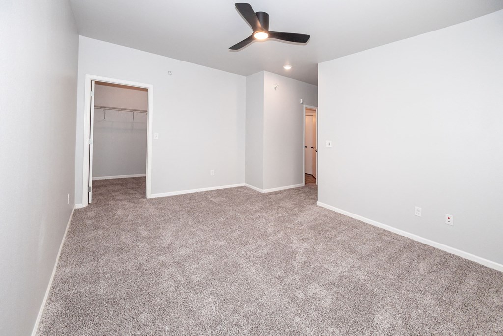 A room with a ceiling fan at Meadowlark Place Apartments, Iowa, 50111