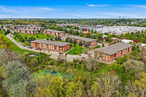 A large building complex surrounded by trees.