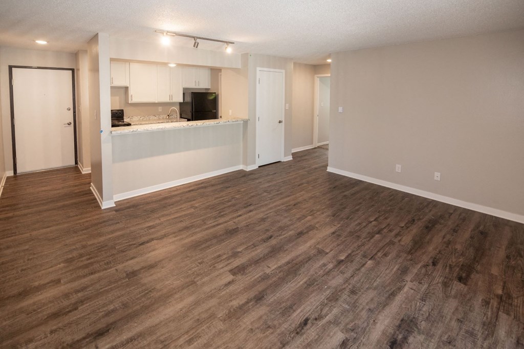 an empty living room and kitchen with a wood floor at Rosemont Place Apartments, Des Moines, IA, 50320