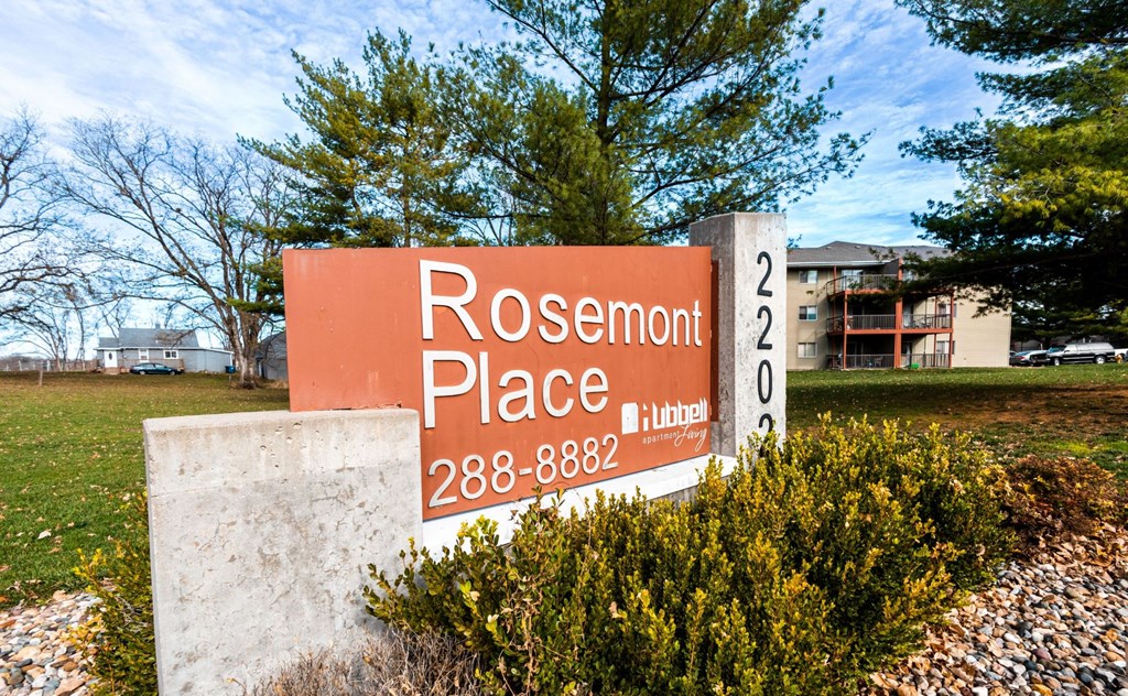 a sign for rosemont place in front of a building at Rosemont Place Apartments, Des Moines