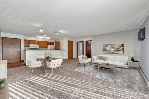 A living room with a dining table and chairs.