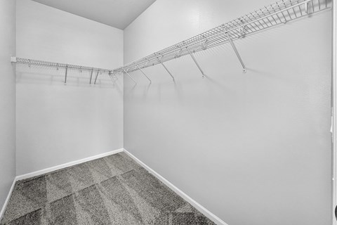 Empty room with a metal rack on the wall.