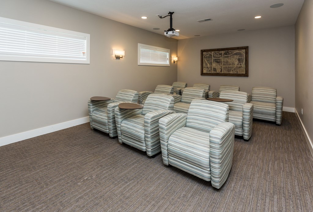 A room with striped chairs and a projector.