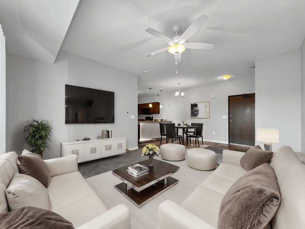 a white living room with couches and a coffee table at Stonegate Crossing Apartments, IOWA, 50325