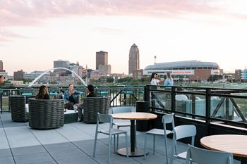 A group of people are sitting on a rooftop terrace.at Level, Des Moines, IA  