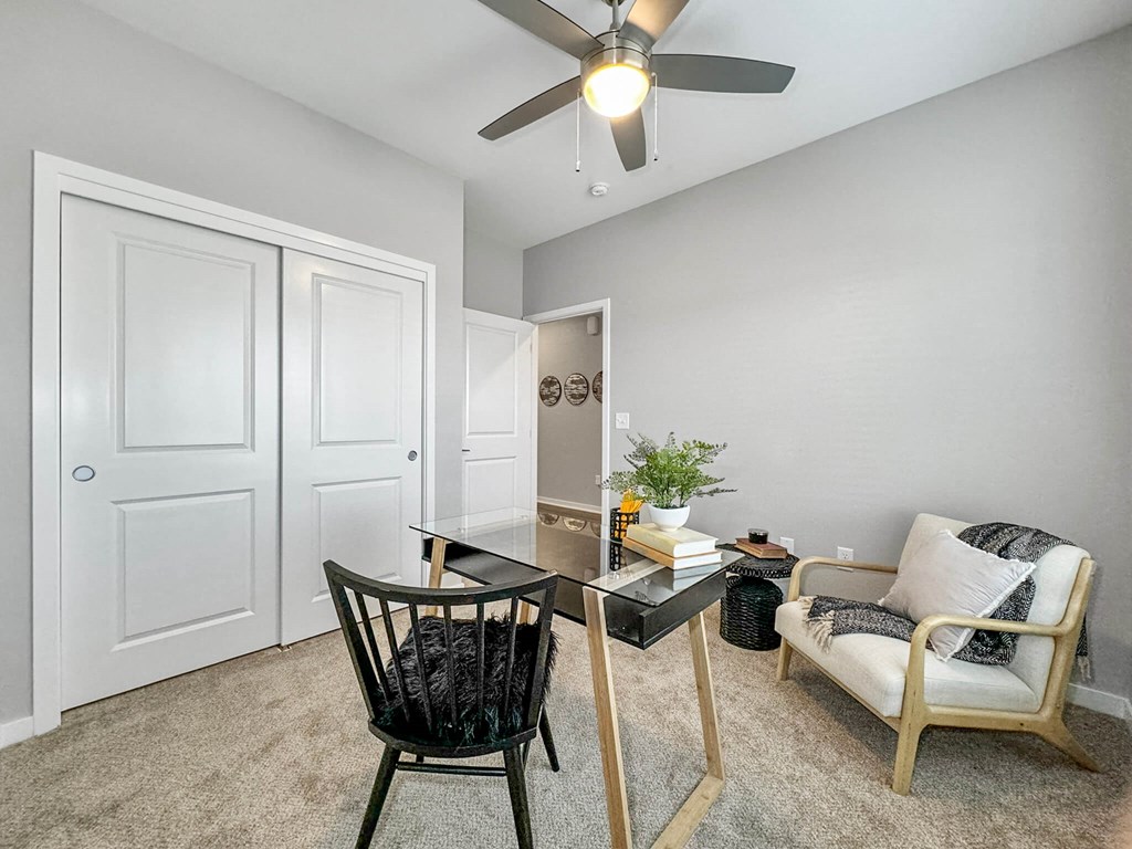 an office with a desk and a ceiling fan at Rialto Townhomes Apartments, Waukee, 50263