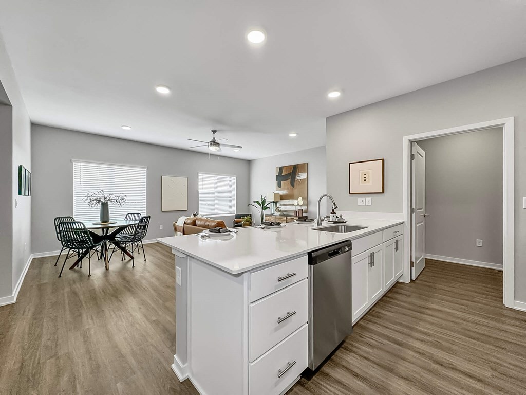 an open kitchen and dining room with a table and chairs at Rialto Townhomes Apartments, Iowa