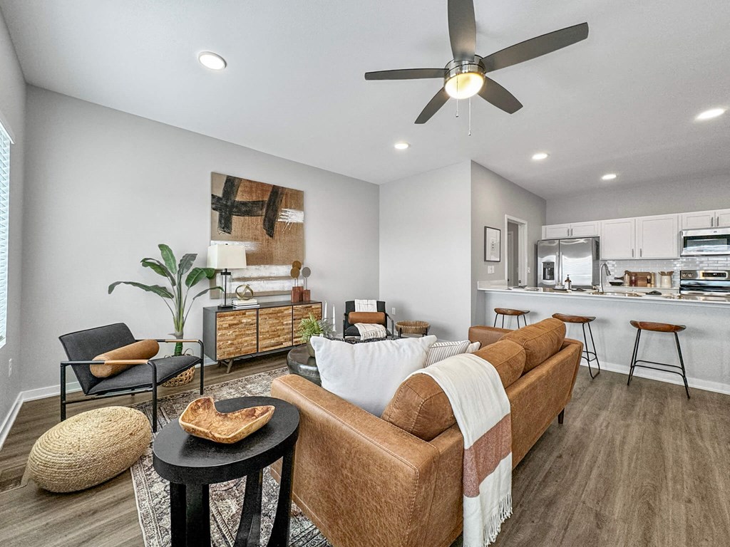 a living room with a couch and a ceiling fan at Rialto Townhomes Apartments, Waukee, 50263