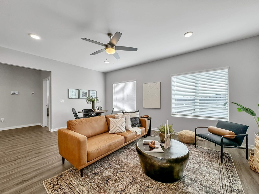 a living room with a couch and a ceiling fan at Rialto Townhomes Apartments, Waukee
