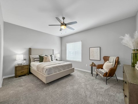 a bedroom with a ceiling fan and a bed at Rialto Townhomes Apartments, Waukee, IA, 50263