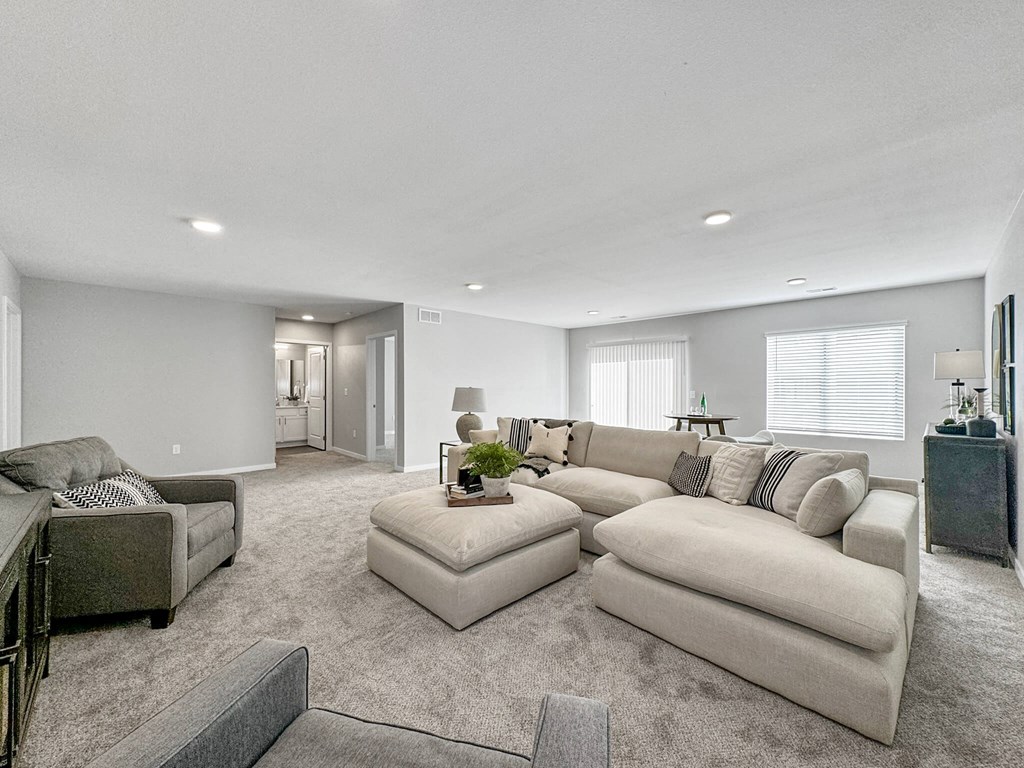 a living room with a couch and a chair at Rialto Townhomes Apartments, Iowa