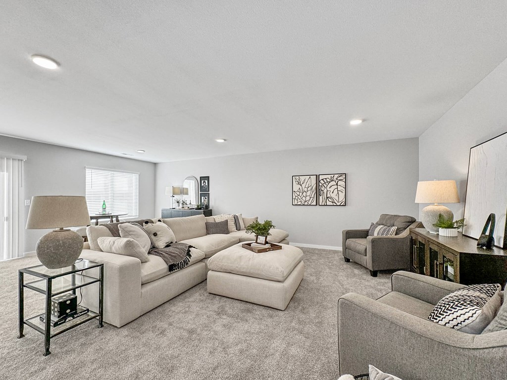 a living room with couches and chairs at Rialto Townhomes Apartments, Waukee