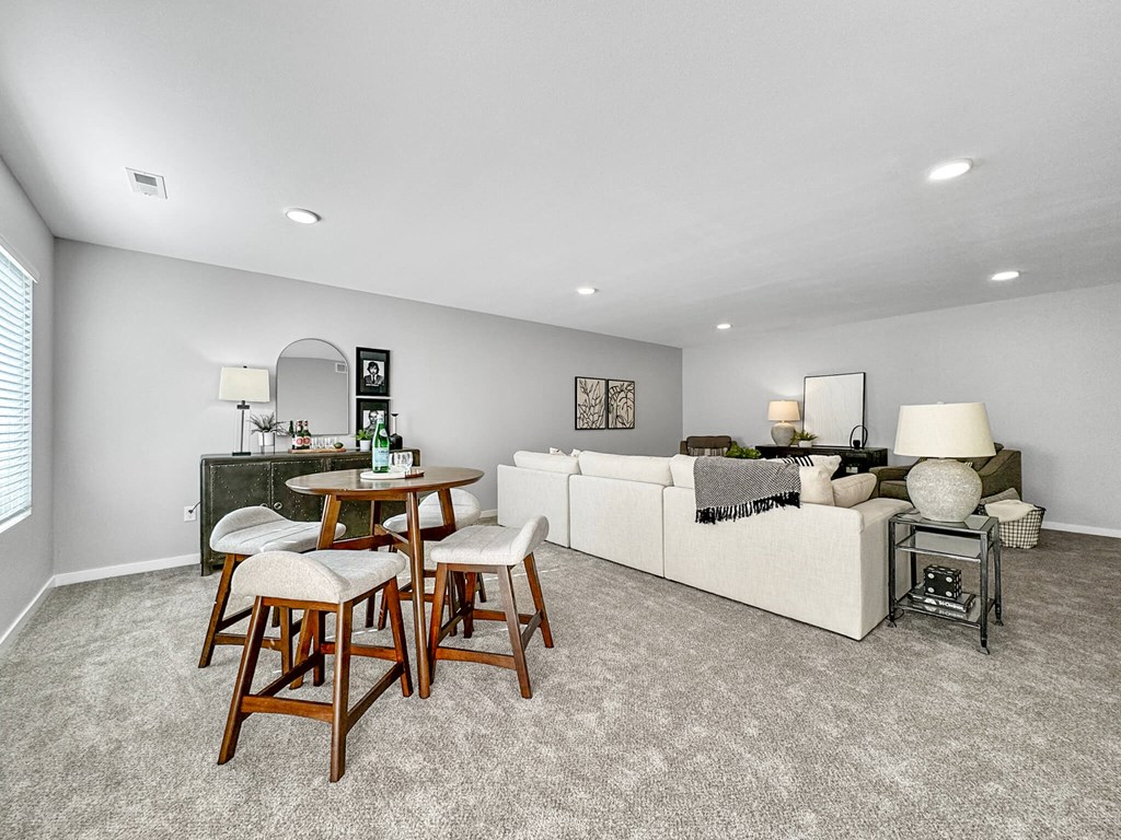 a living room with a couch and a table at Rialto Townhomes Apartments, Waukee, Iowa