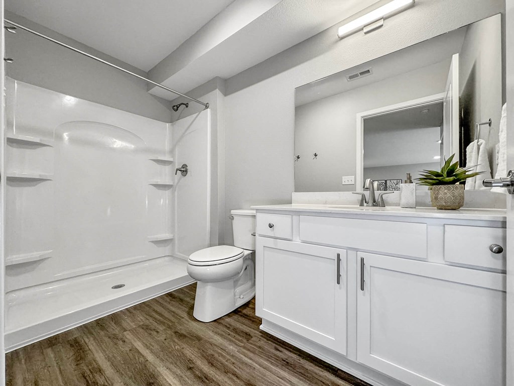 a bathroom with a toilet and a shower and a sink at Rialto Townhomes Apartments, Waukee