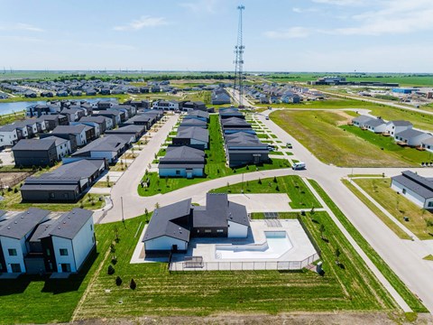 an aerial view of a neighborhood of houses in a field at Rialto Townhomes Apartments, Waukee, IA, 50263