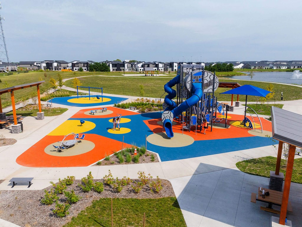 an aerial view of a playground with a blue slide at Rialto Townhomes Apartments, Waukee, IA