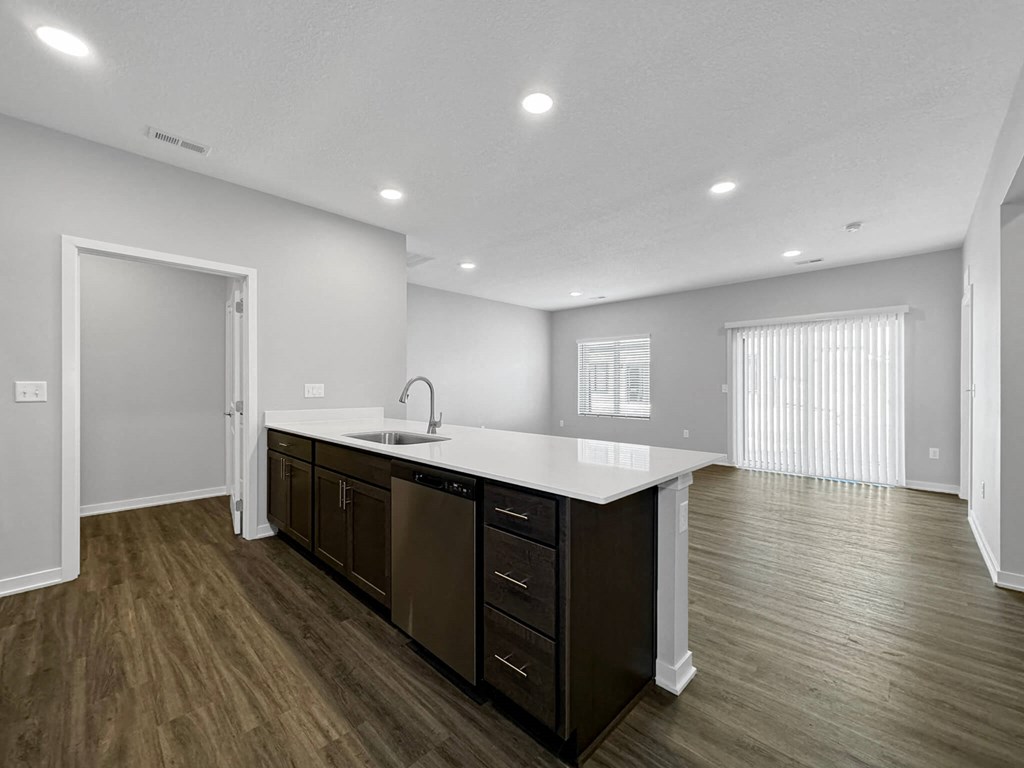 the kitchen is open to the living room and dining room at Rialto Townhomes Apartments, Waukee, IA