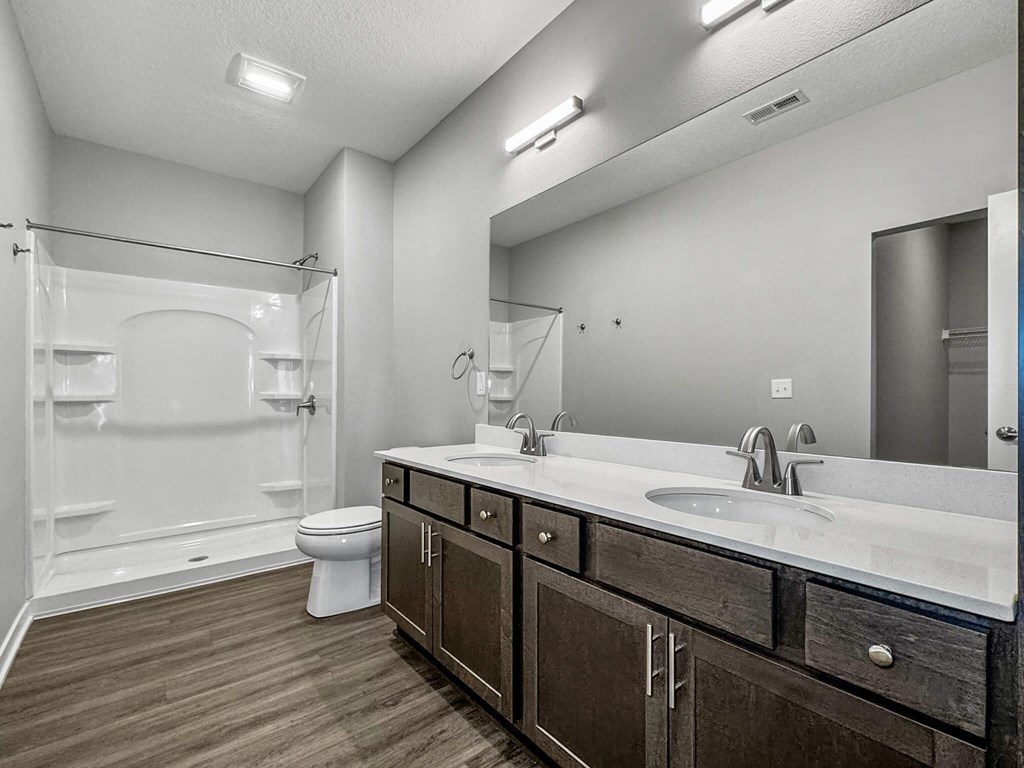 a bathroom with a sink and a toilet and a shower at Rialto Townhomes Apartments, Iowa
