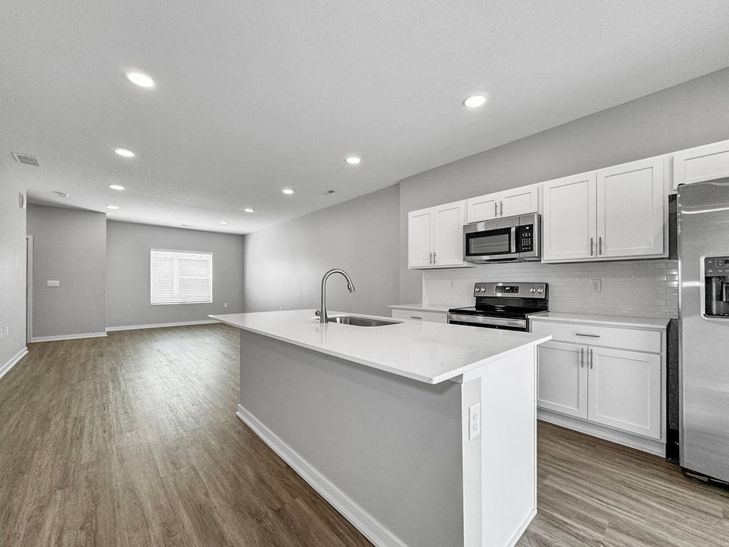 a renovated kitchen with white cabinets and a white counter top at Rialto Townhomes Apartments, Waukee, Iowa
