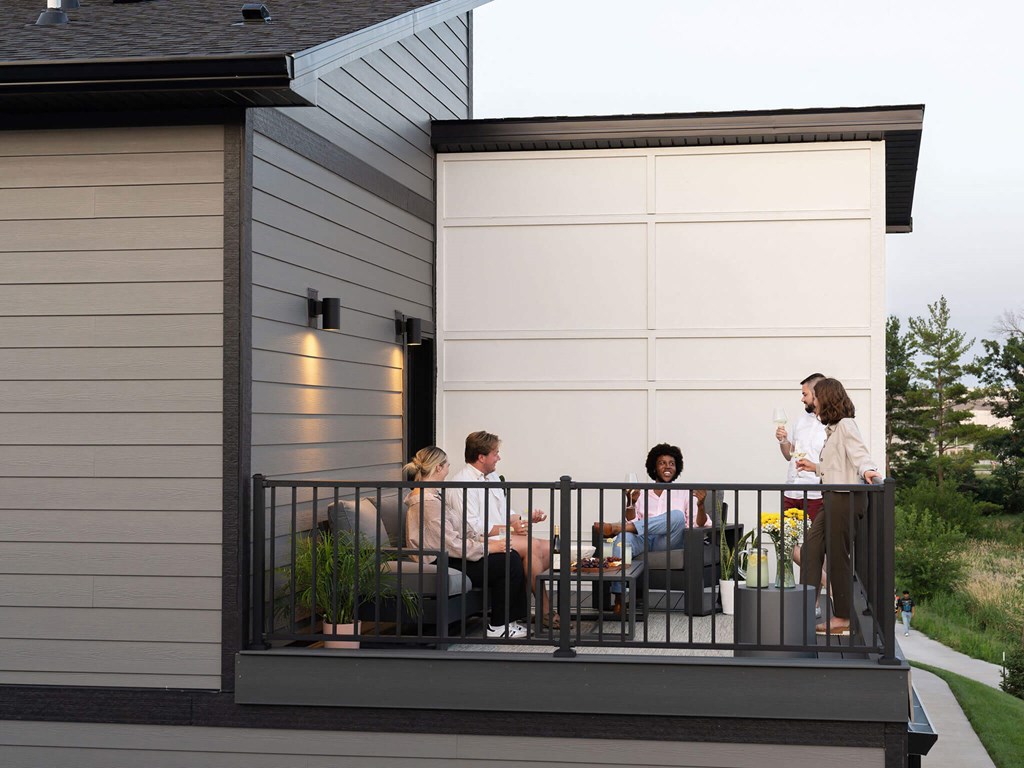 a group of people sitting on a balcony at Rialto Townhomes Apartments, Waukee, IA