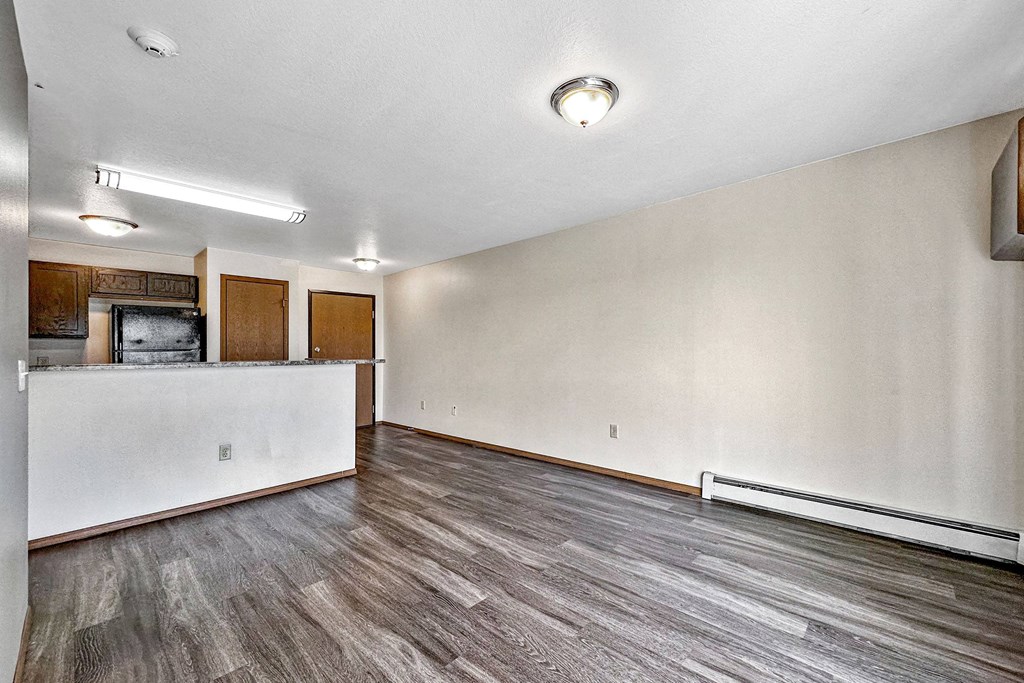 A room with wooden flooring and a white wall at Penbrooke Place Apartments, Sioux Falls, SD, 57106