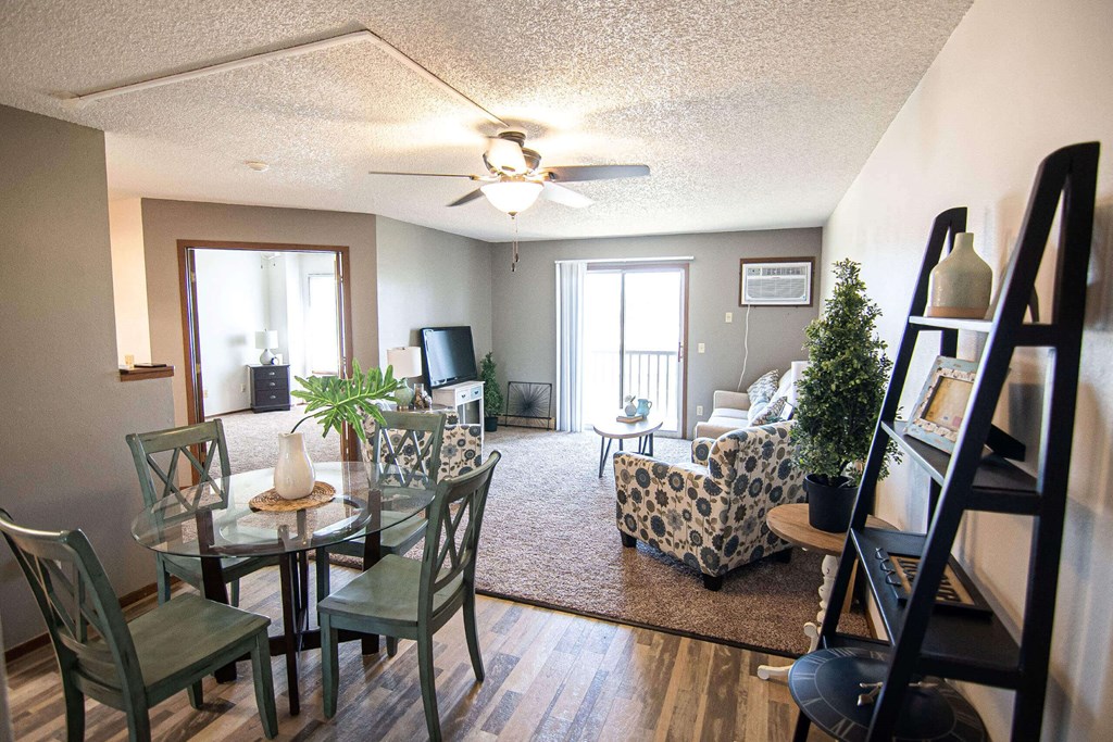 A living room with a glass table and chairs at Penbrooke Place Apartments, Sioux Falls, SD