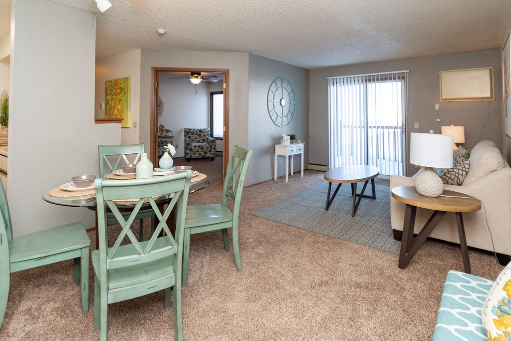 A living room with a dining table and chairs at Penbrooke Place Apartments, Sioux Falls, 57106