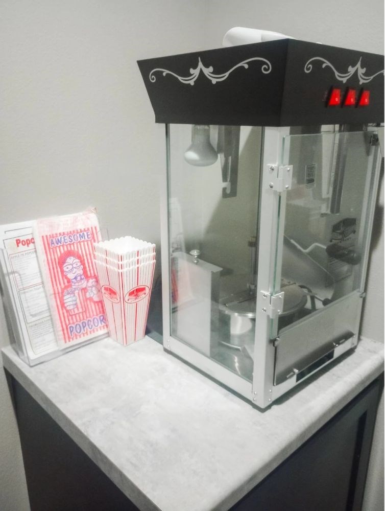 A machine with a red light on is on a table.