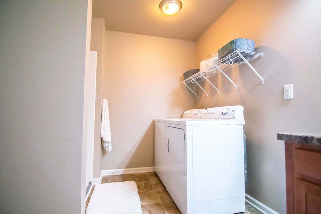 A white washing machine in a laundry room.