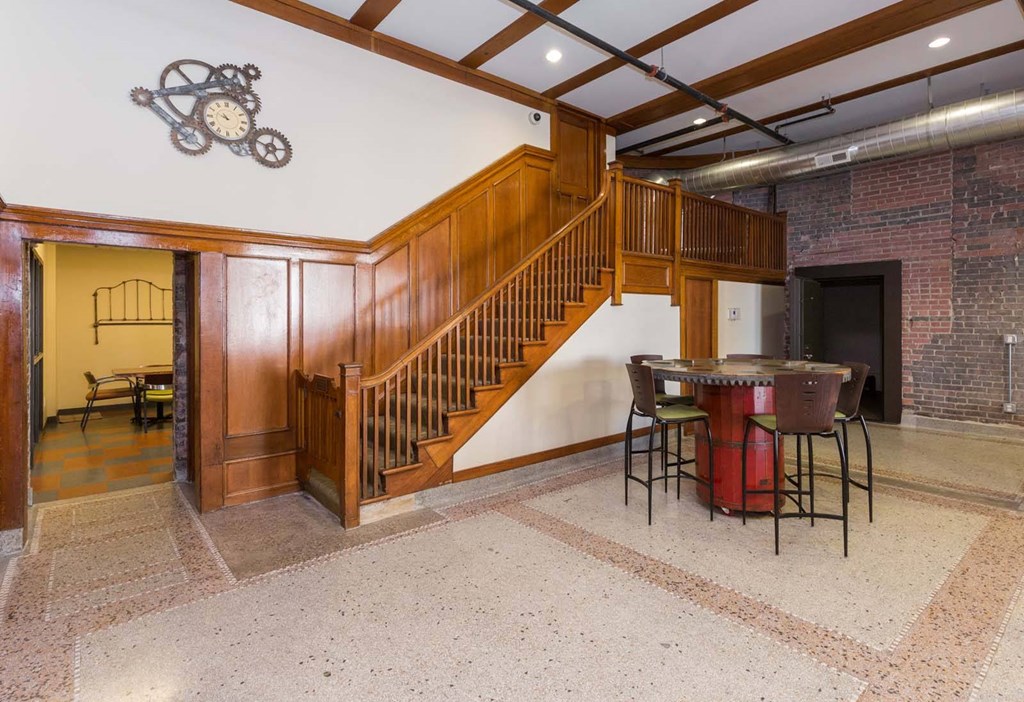 A room with a staircase and a fireplace.at Riverpoint Lofts, Iowa   