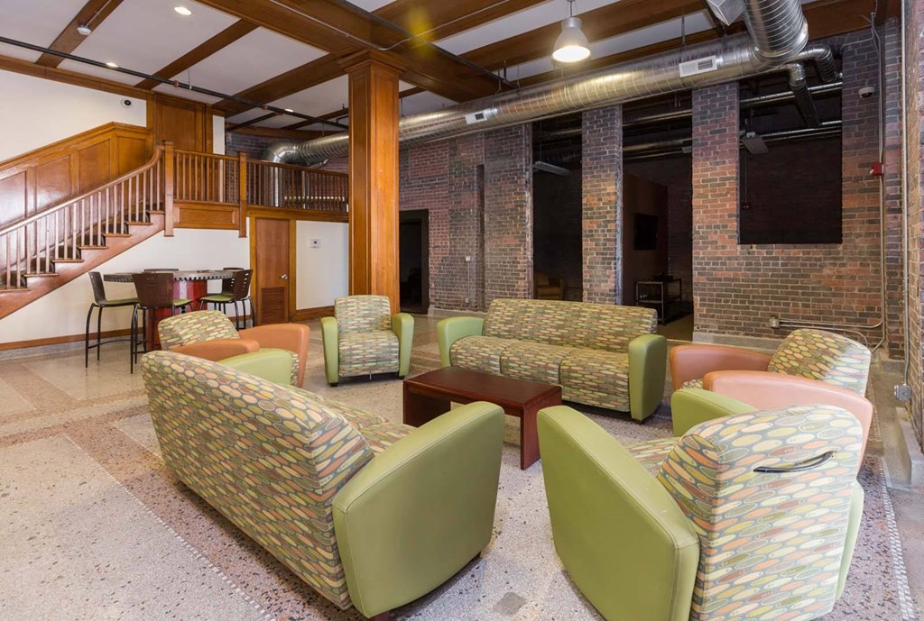 A room with a staircase and a couch.at Riverpoint Lofts, Des Moines, 50309