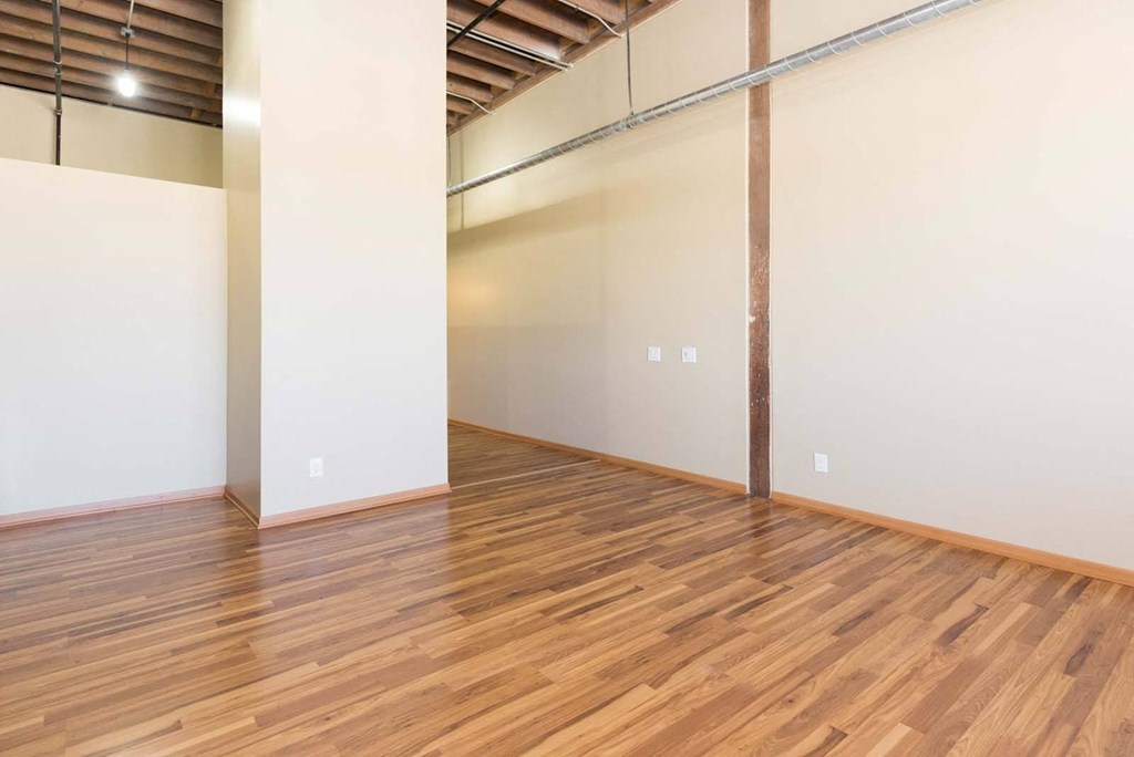 A room with wooden flooring and white walls.at Riverpoint Lofts, Des Moines