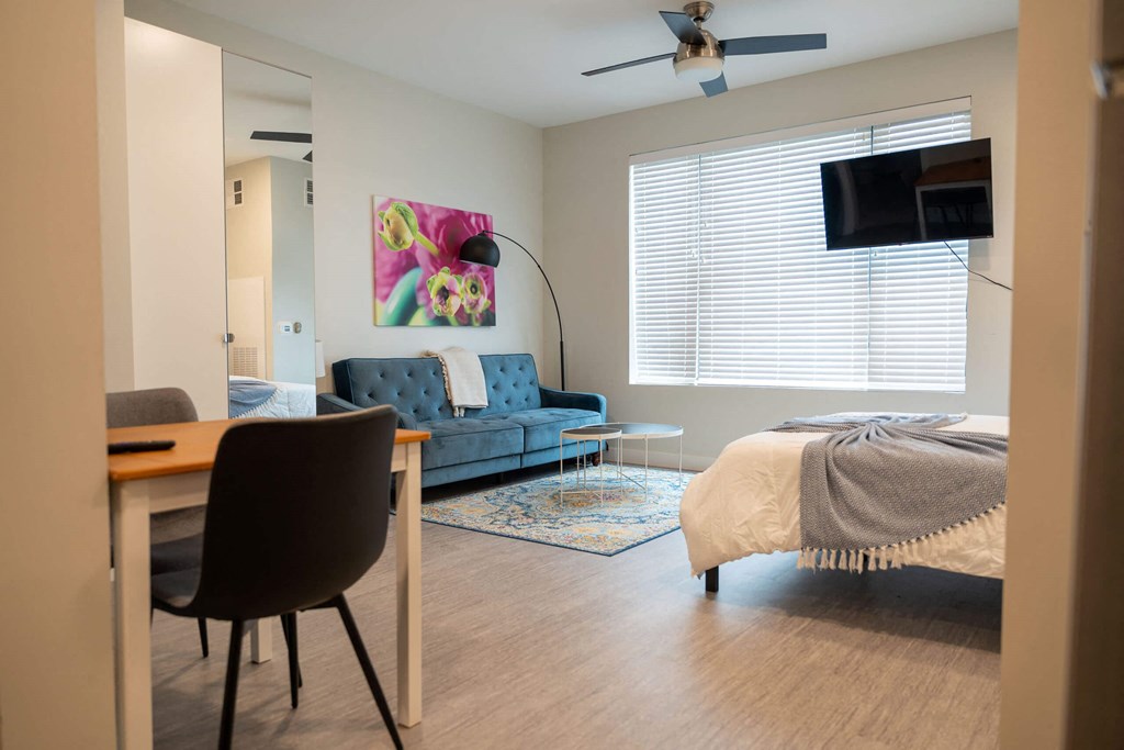 a bedroom and living room with a couch and a bed at Canary Lofts, Iowa, 50311