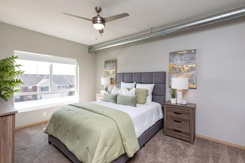a bedroom with a large bed and a ceiling fan at Lake Shore Apartments, Iowa, 50021