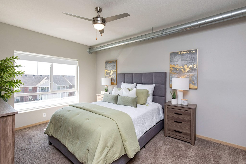 a bedroom with a large bed and a ceiling fan a bedroom with a large bed and a ceiling fan at Lake Shore Apartments, Iowa, 50021