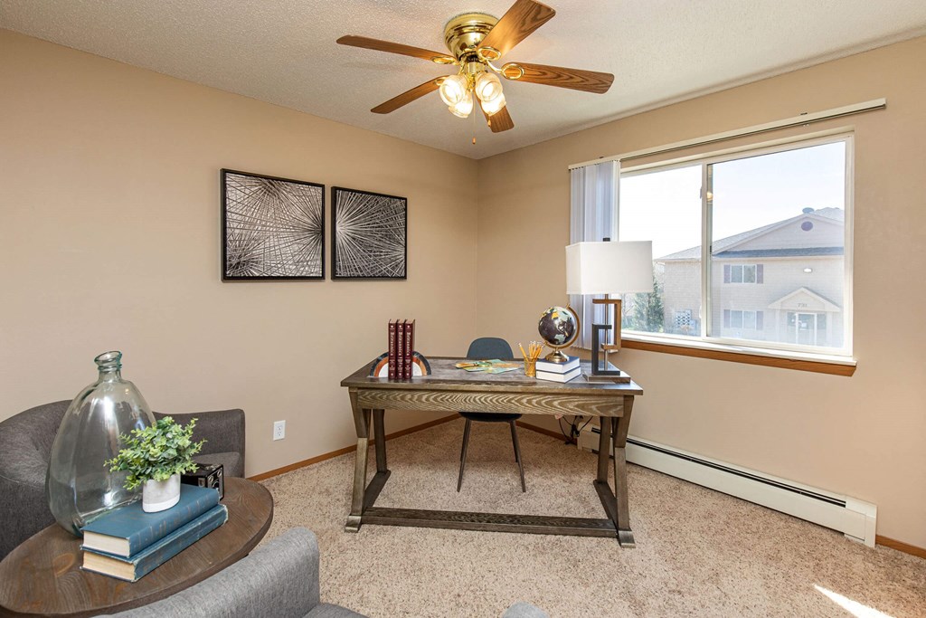 A room with a table, chairs, and a ceiling fan at Lake Shore Park, Ankeny, IA 50021