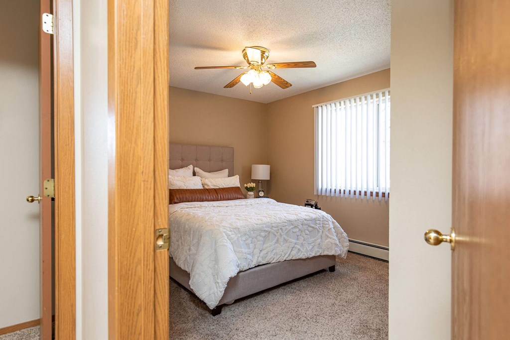 a bedroom with a bed and a closet at Lake Shore Park, Ankeny, Iowa