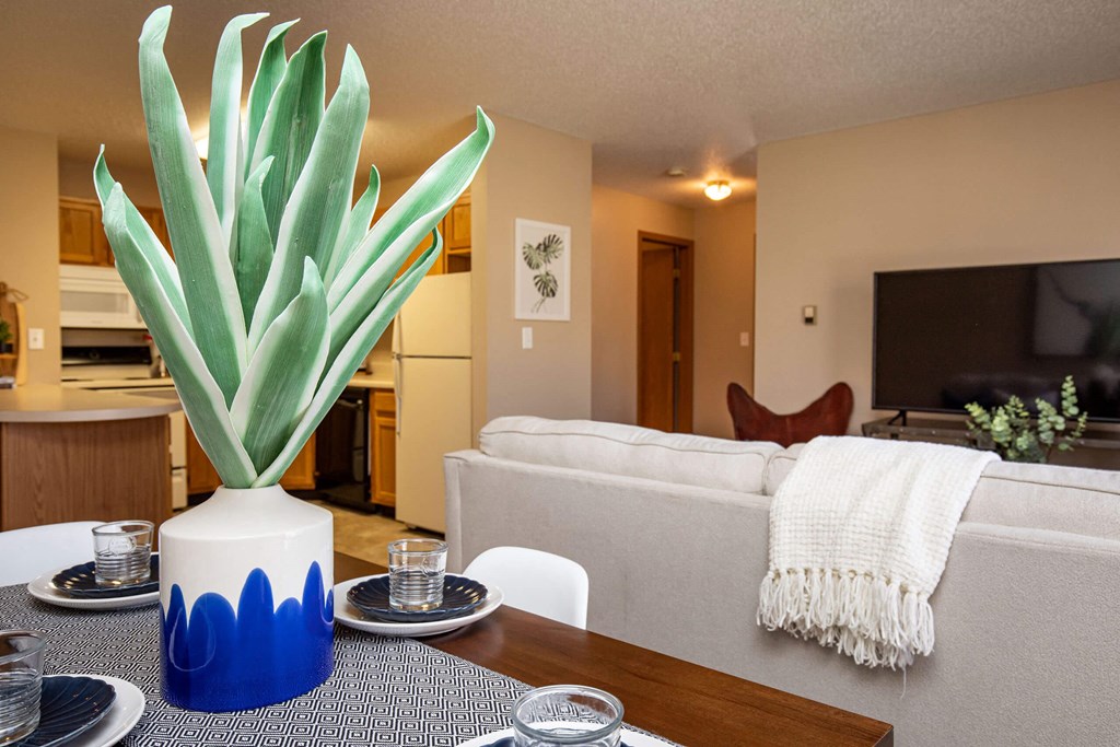a living room with a couch and a table with a plant at Lake Shore Park, Ankeny, IA 50021